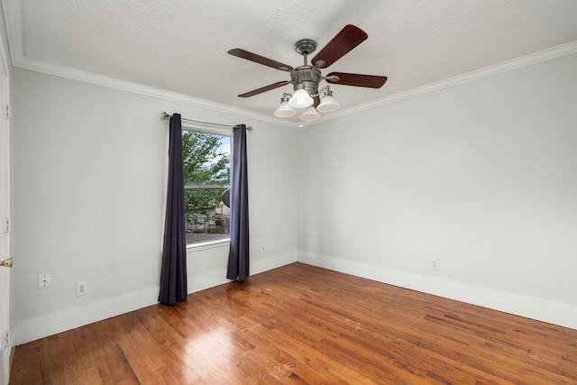unfurnished room featuring wood finished floors, ceiling fan, crown molding, and baseboards