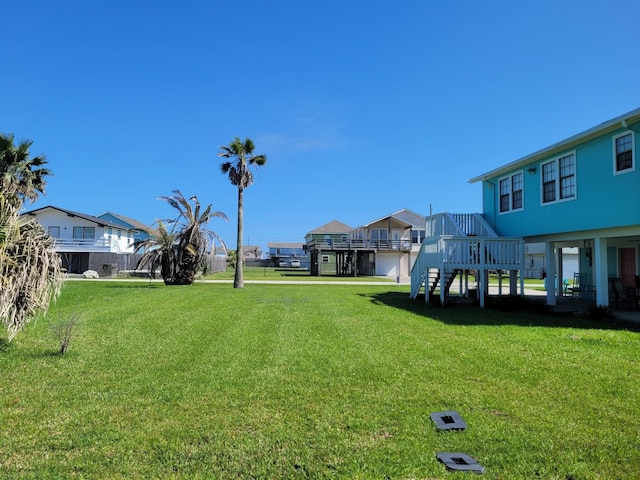 16606 John Davis Rd, Jamaica Beach, TX 77554 - view of yard with a residential view, a wooden deck, and stairway