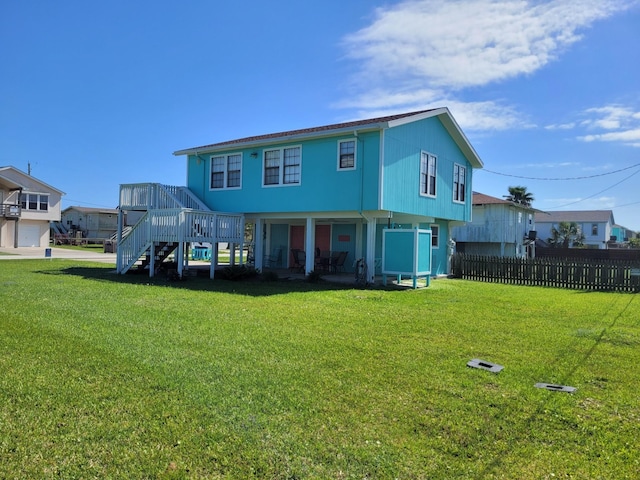 16606 John Davis Rd, Jamaica Beach, TX 77554 - back of property featuring a deck, a yard, stairway, and fence