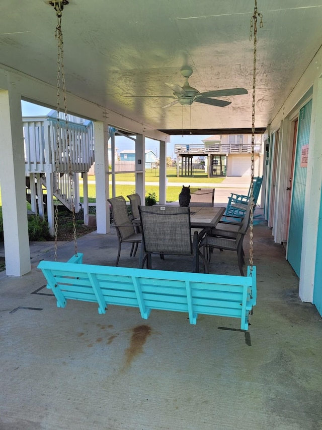16606 John Davis Rd, Jamaica Beach, TX 77554 - view of patio with stairway, ceiling fan, and outdoor dining space