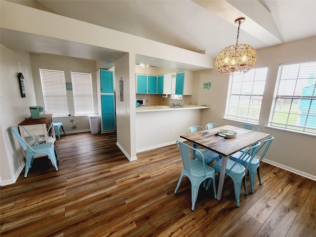 16606 John Davis Rd, Jamaica Beach, TX 77554 - dining area featuring an inviting chandelier, dark wood-style floors, and baseboards