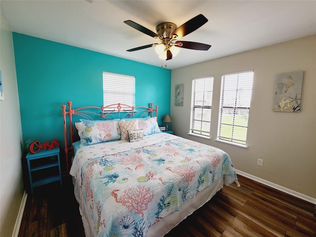 16606 John Davis Rd, Jamaica Beach, TX 77554 - bedroom featuring wood finished floors, ceiling fan, and baseboards