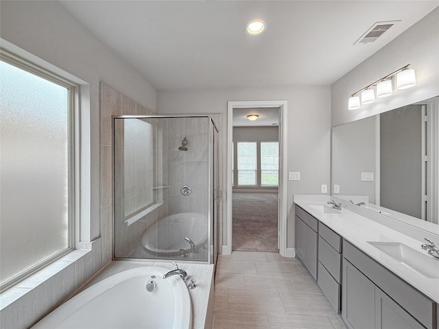 full bath with a garden tub, a stall shower, a sink, and visible vents