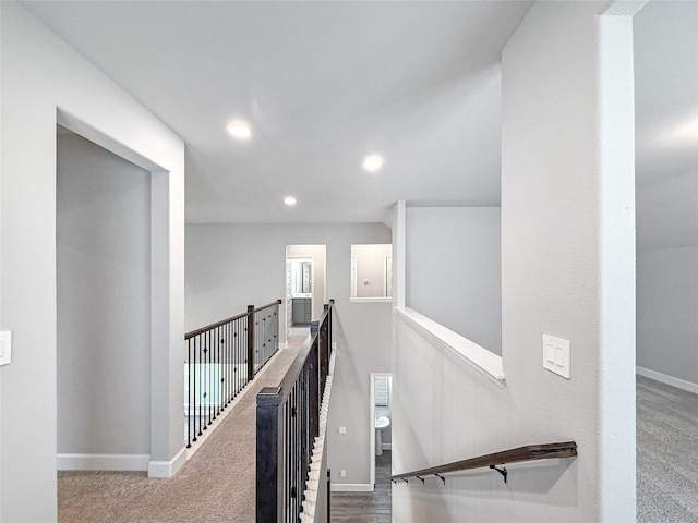 hallway featuring an upstairs landing, recessed lighting, carpet floors, and baseboards