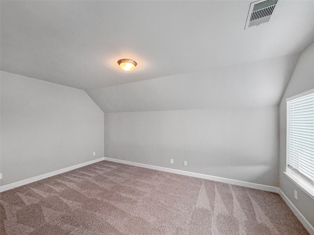 bonus room with visible vents, vaulted ceiling, carpet, and baseboards