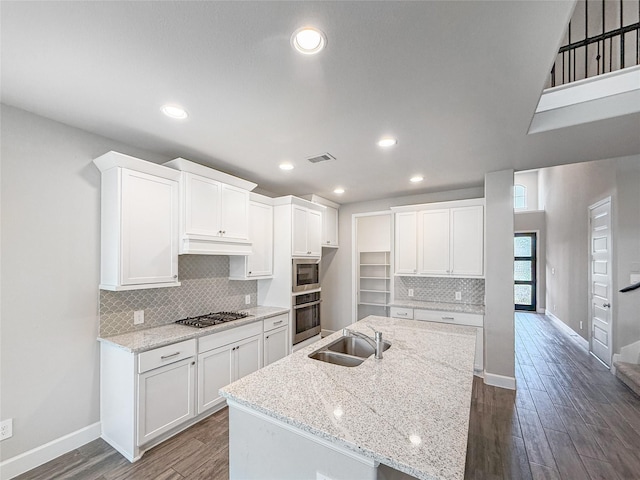 kitchen featuring baseboards, stainless steel appliances, dark wood-style flooring, and a sink
