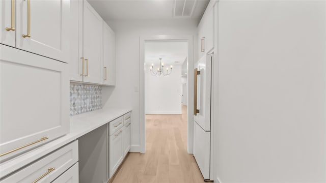 9302 Bassoon Dr, Houston, TX 77025 - hall featuring light wood-style floors and a chandelier