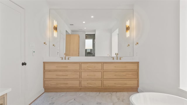 9302 Bassoon Dr, Houston, TX 77025 - full bathroom with double vanity, a freestanding tub, marble finish flooring, and recessed lighting
