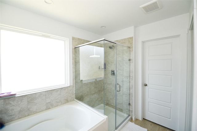 1219 Ricasoli Dr, Richmond, TX 77406 - bathroom with visible vents, a shower stall, and a garden tub