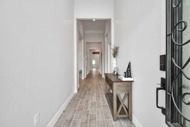 corridor featuring baseboards and light wood-style floors