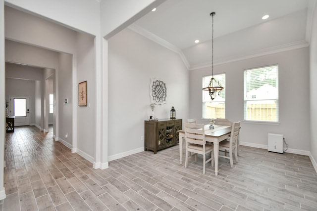 dining area featuring crown molding, baseboards, light wood-type flooring, recessed lighting, and a notable chandelier