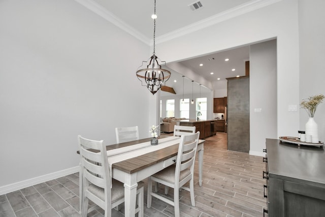 dining space featuring wood tiled floor, baseboards, visible vents, a notable chandelier, and crown molding
