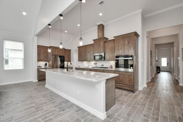kitchen with a kitchen island with sink, decorative backsplash, stainless steel appliances, a sink, and visible vents