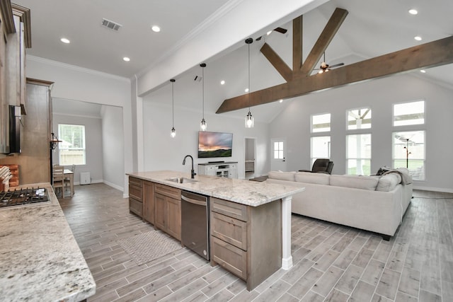 kitchen with a sink, appliances with stainless steel finishes, light wood-style floors, visible vents, and baseboards