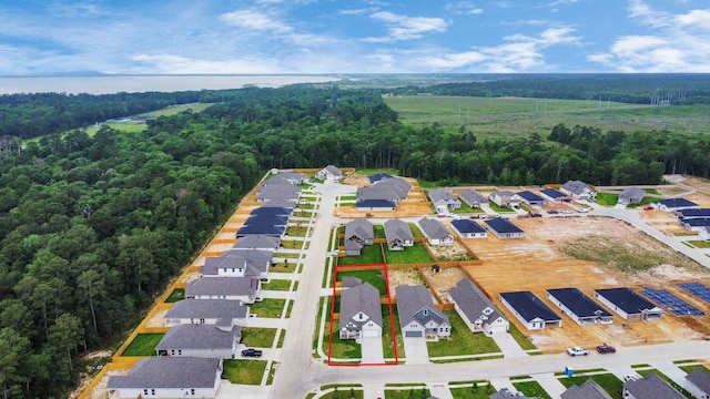 birds eye view of property featuring a residential view and a view of trees