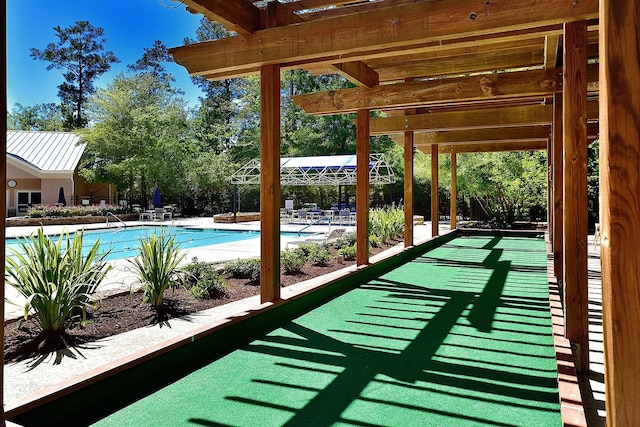 community pool with a bocce ball area and a patio area