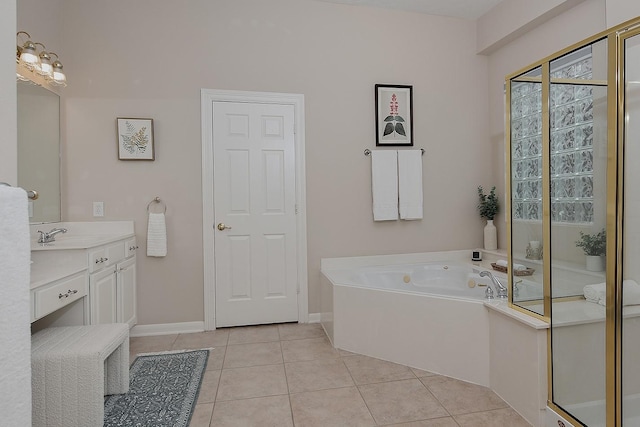 full bathroom featuring tile patterned flooring, a bath, vanity, and baseboards
