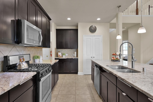 8107 Lockridge Terrace Ln, Cypress, TX 77433 - kitchen with a sink, stainless steel appliances, decorative backsplash, light tile patterned flooring, and light stone counters