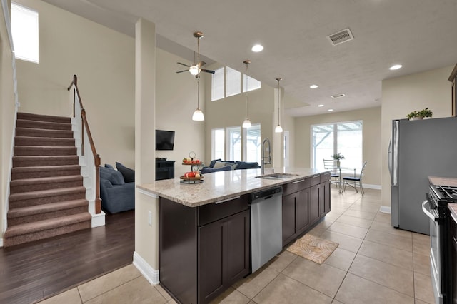 8107 Lockridge Terrace Ln, Cypress, TX 77433 - kitchen featuring a sink, visible vents, black range with gas cooktop, dishwasher, and open floor plan