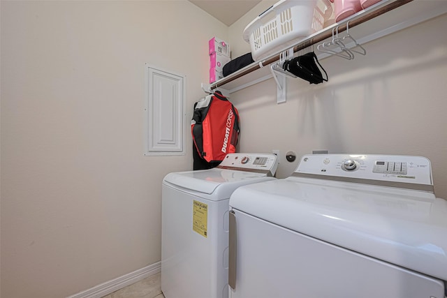 clothes washing area with baseboards, separate washer and dryer, laundry area, and light tile patterned flooring