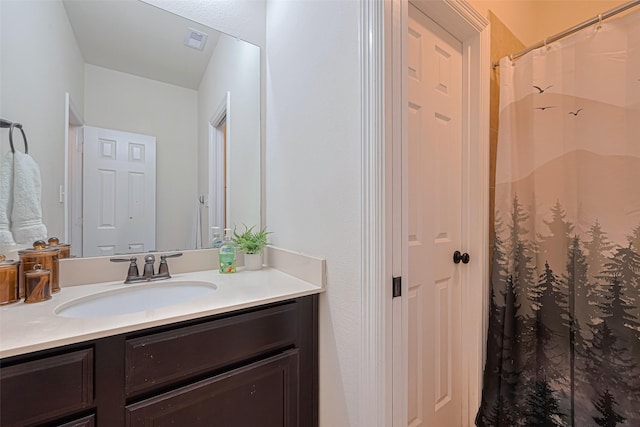bathroom featuring visible vents, curtained shower, and vanity