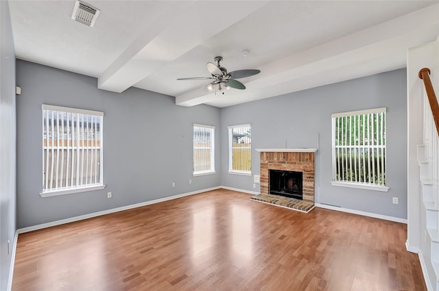 3006 Eagle Nest Ln, Humble, TX 77396 - unfurnished living room with ceiling fan, wood finished floors, baseboards, and a brick fireplace