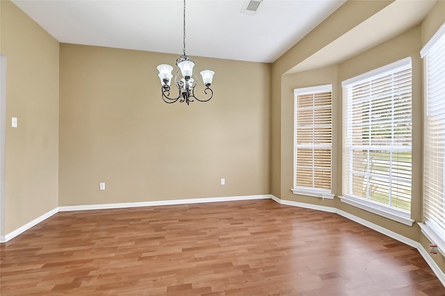 3006 Eagle Nest Ln, Humble, TX 77396 - spare room with a chandelier, healthy amount of natural light, and light wood-type flooring