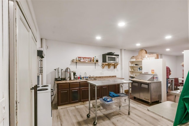 kitchen with stainless steel microwave, open shelves, dark brown cabinets, white electric range, and light wood finished floors