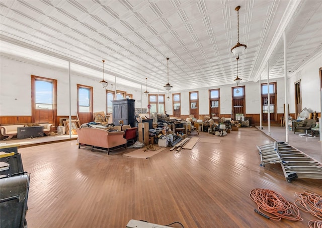 misc room featuring wooden walls, wood finished floors, and wainscoting