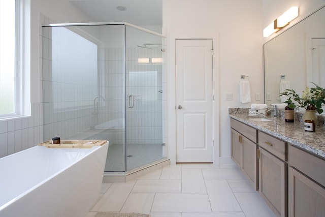 1546 W Tidwell Rd, Houston, TX 77091 - full bathroom featuring a shower stall, vanity, a freestanding bath, and tile patterned floors