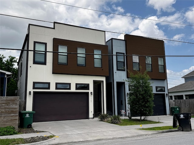 803 E 38th St, Houston, TX 77022 - view of front of house featuring a garage, driveway, fence, and stucco siding
