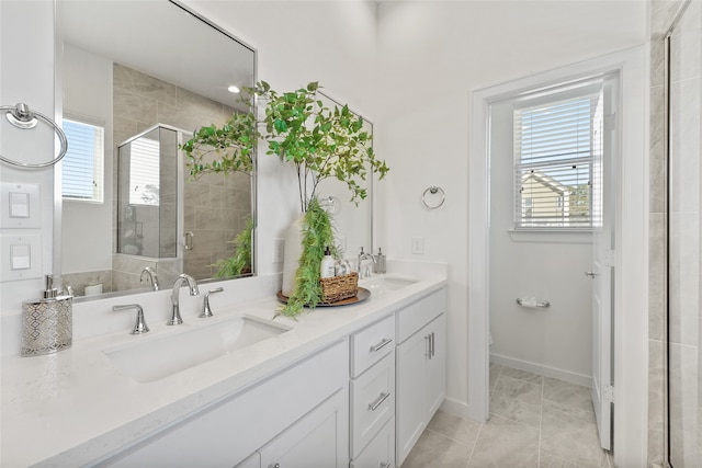 1207 Highland Vineyard Ln, Houston, TX 77091 - bathroom featuring a stall shower, double vanity, a sink, and baseboards