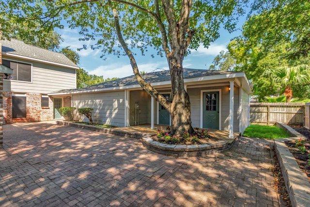 view of front of house with brick siding and fence