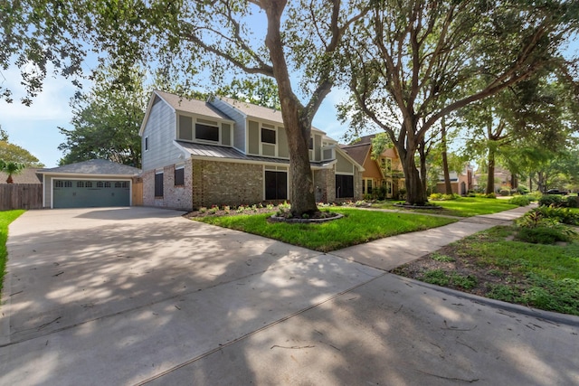 traditional home with a front lawn, a garage, metal roof, driveway, and fence