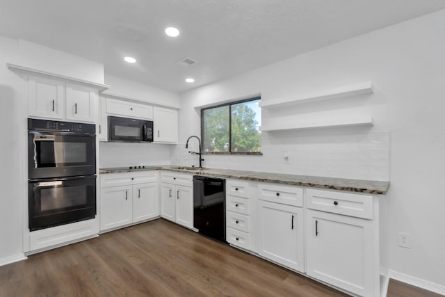 kitchen featuring black appliances, a sink, light stone counters, and open shelves