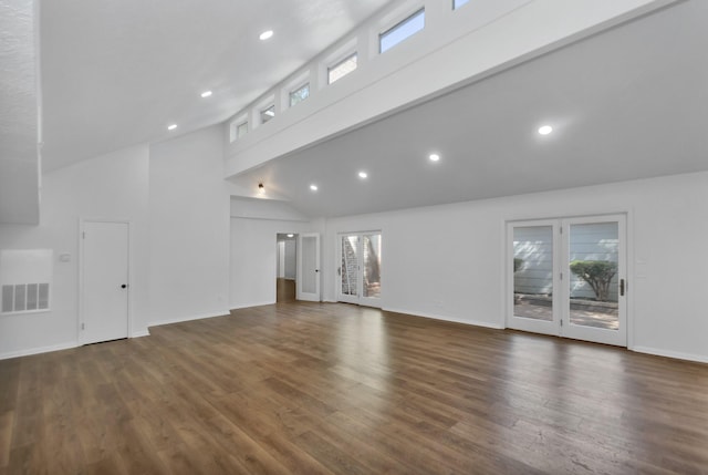 unfurnished living room with a wealth of natural light, visible vents, and high vaulted ceiling