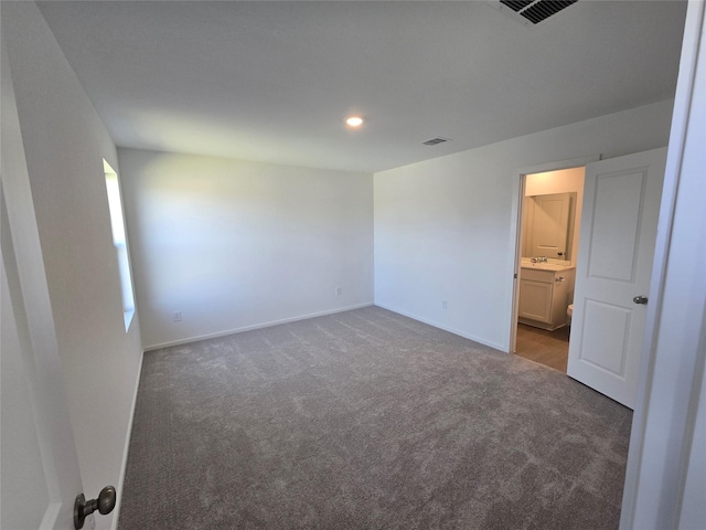 unfurnished bedroom featuring carpet, visible vents, and baseboards