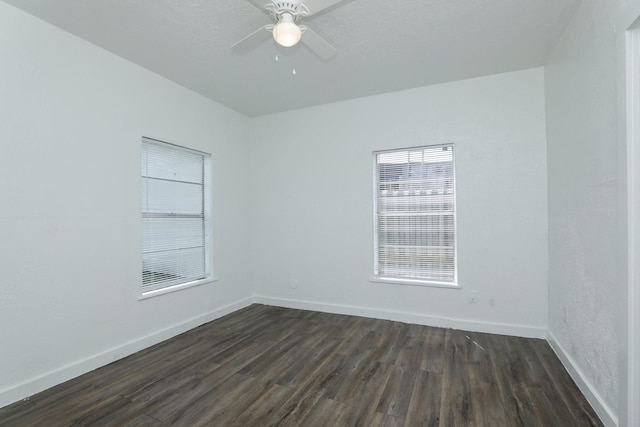 119 W Main St, Baytown, TX 77520 - spare room featuring ceiling fan, dark wood finished floors, and baseboards