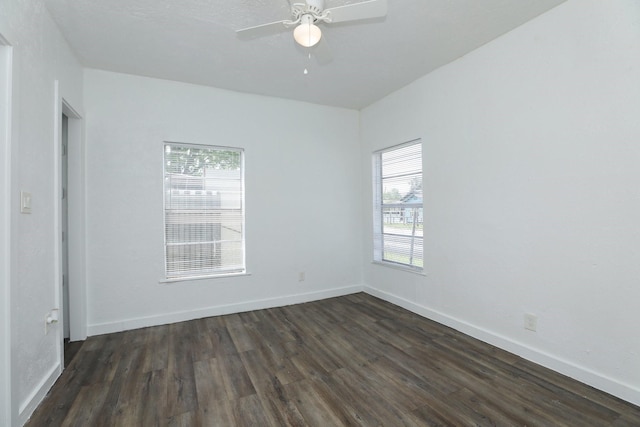 119 W Main St, Baytown, TX 77520 - empty room with dark wood-style floors, baseboards, and a ceiling fan