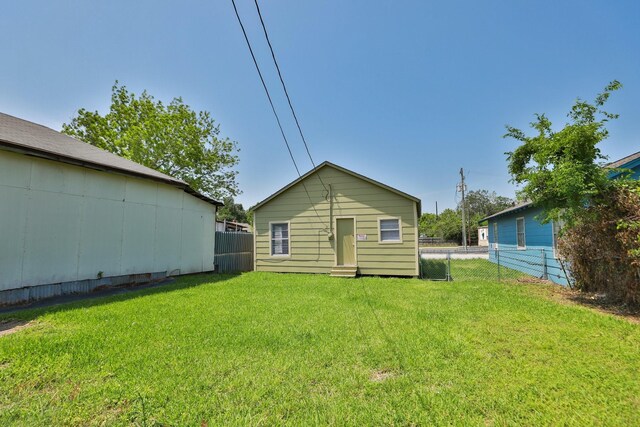 119 W Main St, Baytown, TX 77520 - rear view of property with fence and a yard