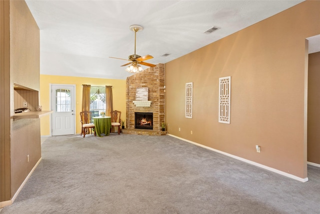 15202 Pebble Lake Dr, Houston, TX 77095 - unfurnished living room with a ceiling fan, a fireplace, vaulted ceiling, light carpet, and baseboards