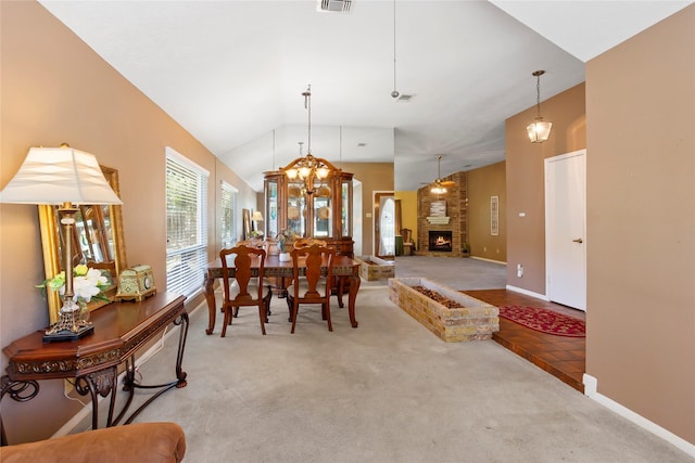 15202 Pebble Lake Dr, Houston, TX 77095 - carpeted dining room with lofted ceiling, baseboards, and a brick fireplace