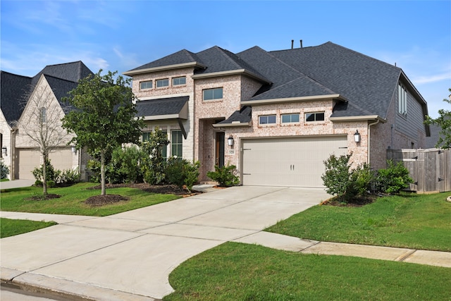 view of front of property featuring a front yard, driveway, and brick siding