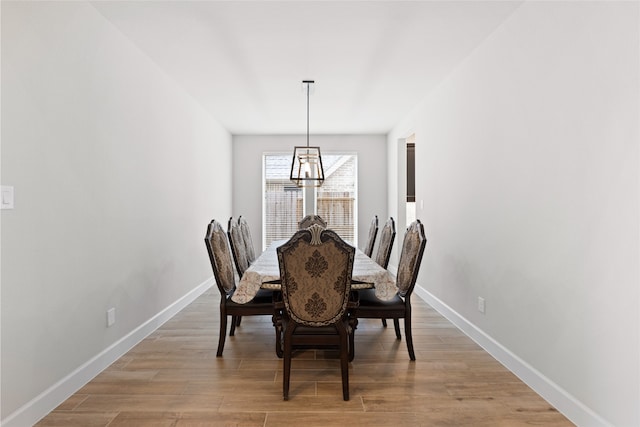 dining space with baseboards and light wood-style floors