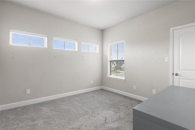 carpeted spare room with baseboards