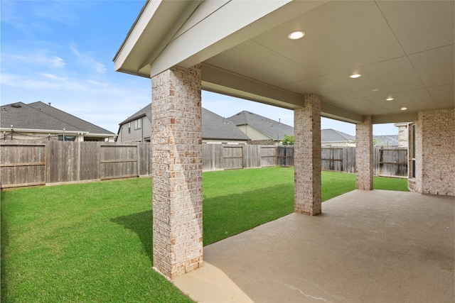 view of yard with a fenced backyard and a patio area