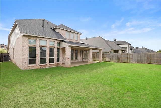 back of house featuring roof with shingles, central air condition unit, and a fenced backyard