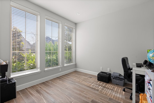 home office featuring wood finished floors and baseboards