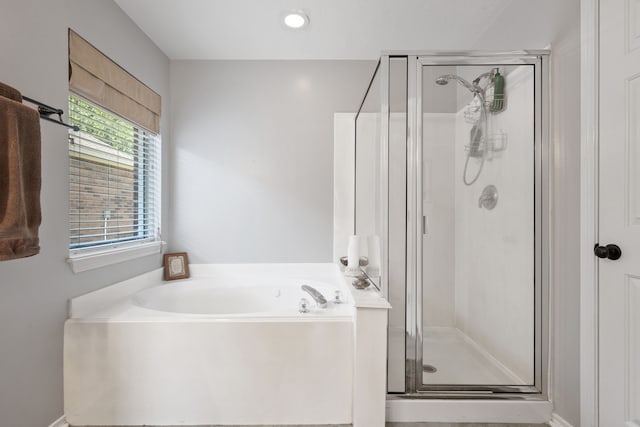 full bath featuring a stall shower and a garden tub