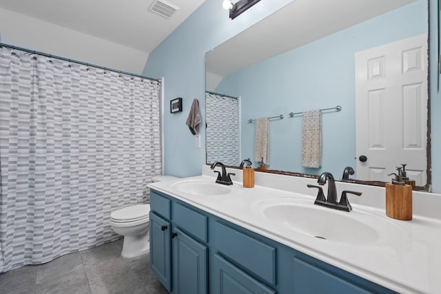 bathroom with toilet, visible vents, a sink, and double vanity